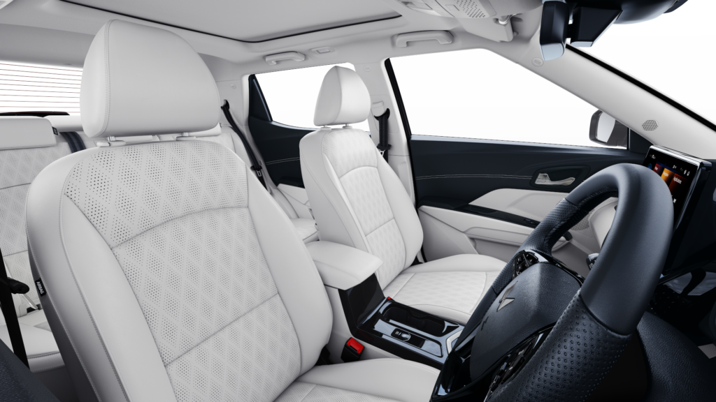 Interior view of Mahindra XUV 3XO with ivory leatherette seats, armrest, and touchscreen infotainment